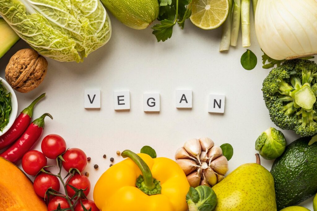 Why Vegan? 15 top view assortment vegetables with word vegan 23 2148853333